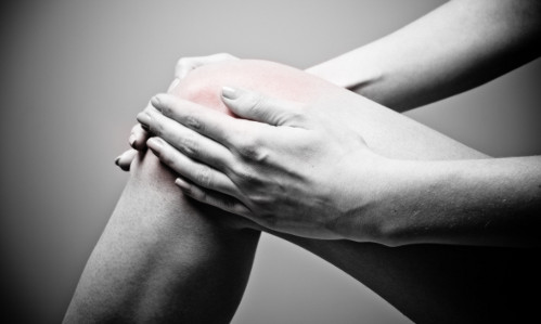 We treat all sports related injurys with the utmost care and compassion. woman holding hurt knee